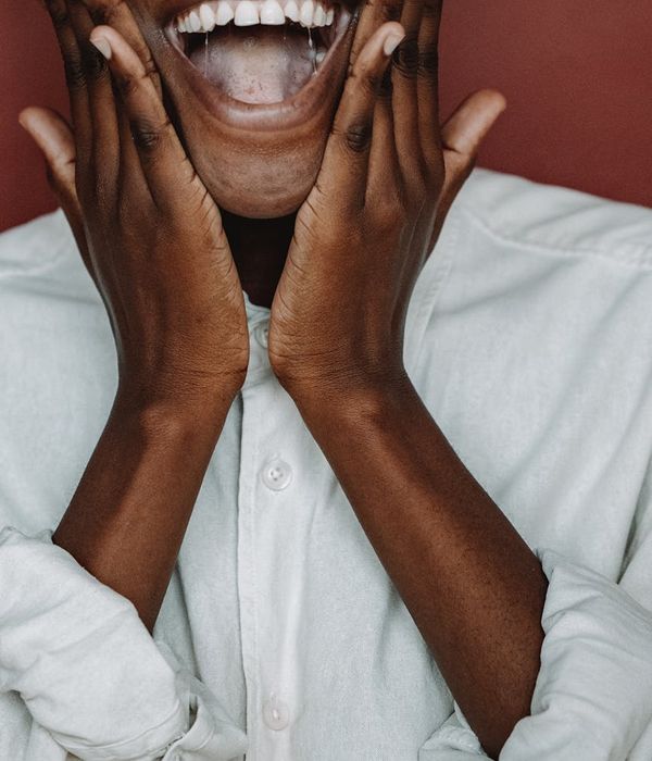 Smiling person feeling energetic and happy after a light workout.